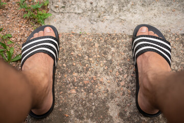 Summer Vibes: Close-Up POV of Feet in Flip-Flops slides