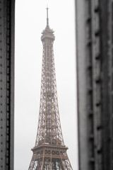 Close-up portrait of the Eiffel Tower between the columns of the Bir Hakeim bridge in the rain in Paris