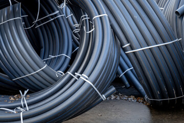 Several rolled up small diameter polyethylene pipes for laying high voltage electric cables...