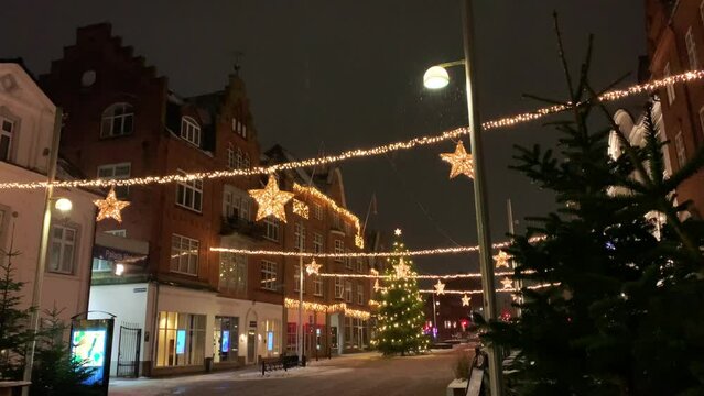  Decorated for Christmas holidays, Denmark, Copenhagen , Viborg, Shopping street in historical center of Aarhus decorated for New Year holidays, Pedestrians Christmas shopping on Stroget at night.