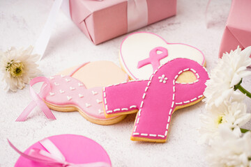Pink cookies with ribbons and flowers on white grunge background. Breast cancer awareness concept