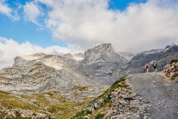 Couple hiking in the National Park Peaks of Europe. Fuente De, Cantabria, Spain