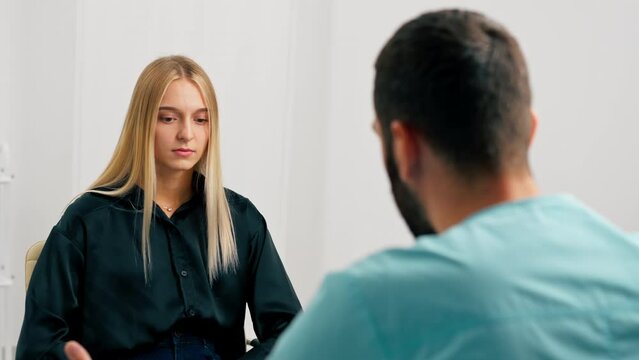 A doctor at a medical center shows girl patient her tests and prescribes further treatment