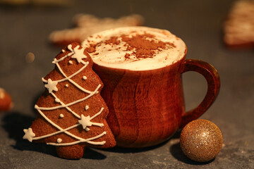 Cup of hot cocoa with gingerbread cookies and Christmas ball on grunge table