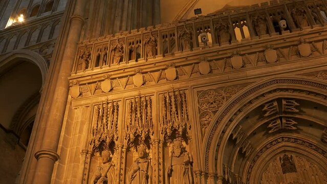 LOW ANGLE VIEW: Beautifully crafted stone quire screen with statues of kings. Magnificent architectural details in every corner of Canterbury Cathedral. Stunning religious and historical monument.