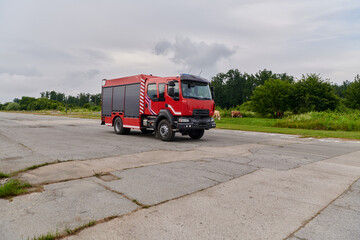 In this captivating scene, a state-of-the-art firetruck, equipped with advanced rescue technology, stands ready with its skilled firefighting team, prepared to intervene and respond rapidly to