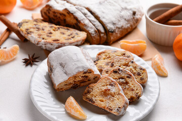 Plate with tasty Christmas stollen on white background