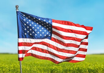 American flag wave over a green field.