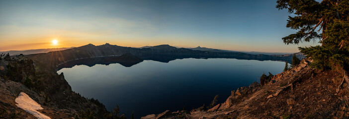 Panorama of Crater Lake as Sun Sets Behind Rim