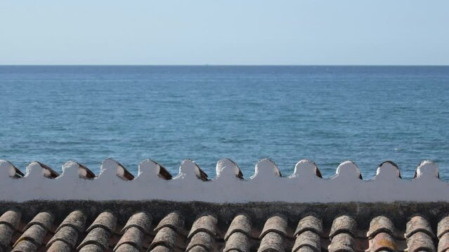 Roof of a mediterranean house together a beach