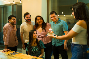 Latin women and men celebrathing a birthday party