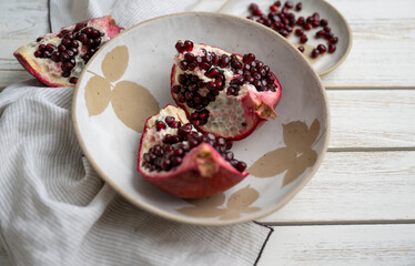 Fresh Opened Pomegranate on Light Colored Plate