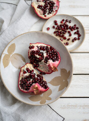 Fresh Opened Pomegranate on Light Colored Plate
