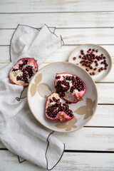 Fresh Opened Pomegranate on Light Colored Plate