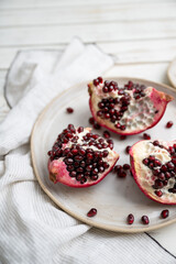 Fresh Opened Pomegranate on Light Colored Plate