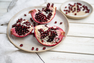 Fresh Opened Pomegranate on Light Colored Plate