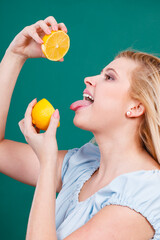 Girl drinking juice from juicy lemon fruit