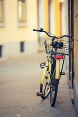 Lonely yellow bicycle in the old town.