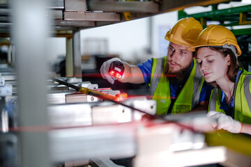 technician engineers team checking the machine and maintenance service. workers looking at spare parts in stock at warehouse factory. laborer with a checklist and laser scanning device on steel part.