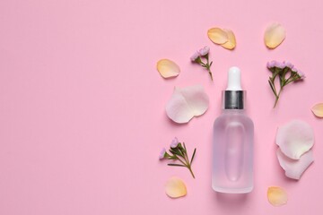 Obraz na płótnie Canvas Bottle of cosmetic serum, flowers and petals on pink background, flat lay. Space for text