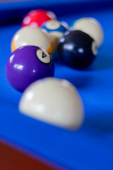 Close-up of Billiard Balls on Bright Blue Felted Pool Table, vertical