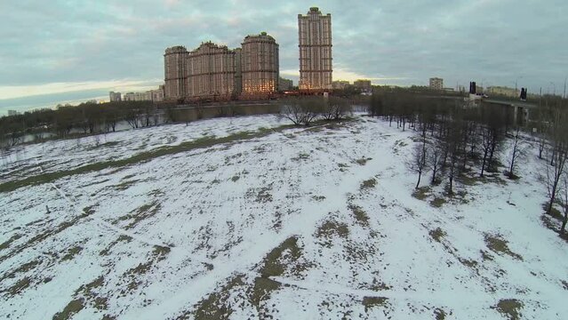 Residential complex on river shore at evening. Aerial view