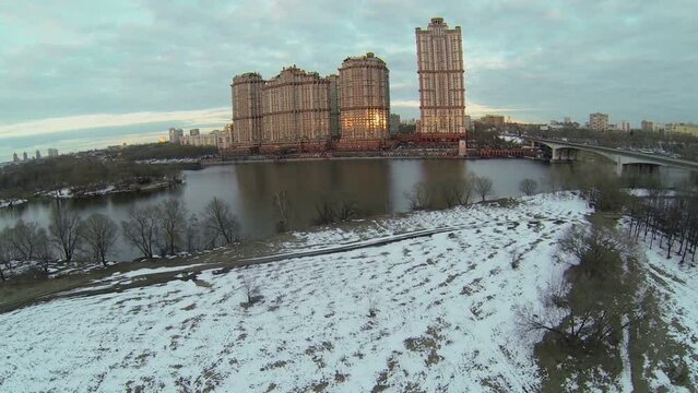 Residential complex Scarlet Sails on river shore at evening.