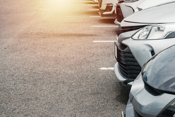 Cars parked in row on outdoor parking. - obrazy, fototapety, plakaty