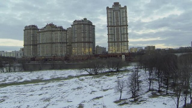 Dwelling complex on river shore at evening. Aerial view