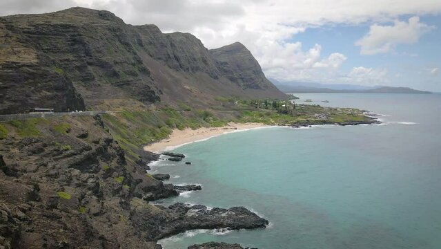A stone-sand tropical beach in Hawaii is the epitome of natural beauty with its radiant turquoise sea.
