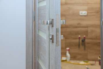 Handyman installed lock handles at wooden door