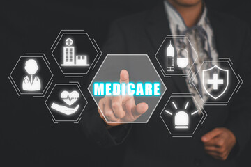 Medicare concept, Business woman hand touching medicare icon on virtual screen.