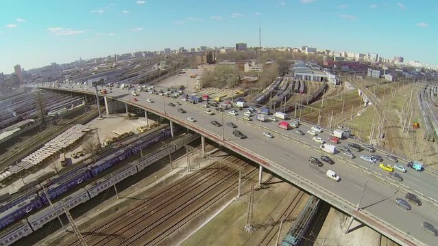 Traffic on Rizhskaya overpass and railroad with trains