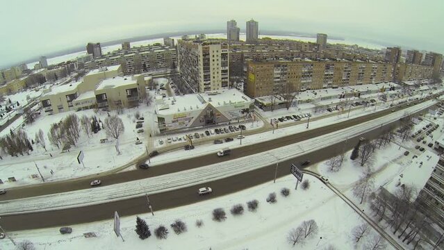 Cityscape with traffic on wide street at winter day. Aerial view