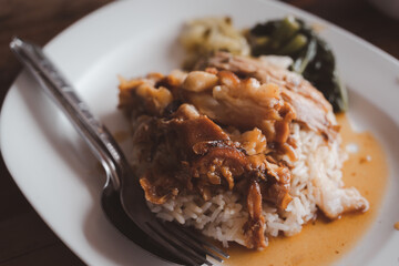 Stewed pork leg on cooked rice. Famous street food in Thailand