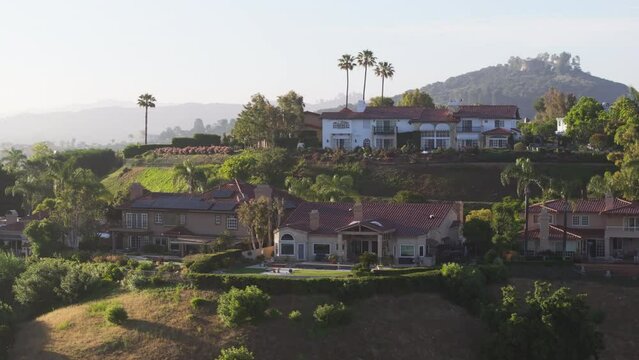 Drone shot of private luxury villas settled on mountain hills in Calabasas, Los Angeles suburban, California, USA. Aerial view of Calabasas residential neighborhood located in picturesque landscape