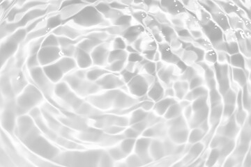 White water with ripples on the surface. Defocus blurred transparent white colored clear calm water surface texture with splashes and bubbles. Water waves with shining pattern texture background.