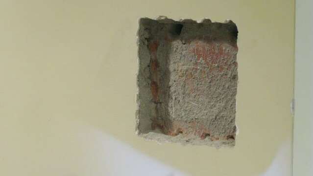 Worker Grooves hole in the wall to install Intercom. Time lapse.