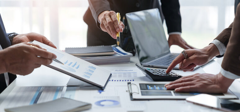 A group of Asian businessmen is meeting to summarize the company's operating results, finances, and profits and losses. Management of startup companies Growing Profitable Management Ideas.