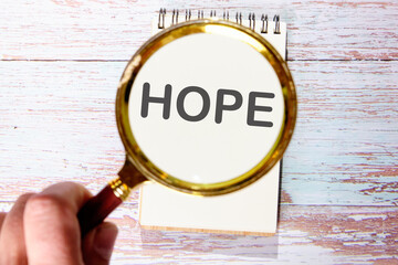 HOPE text seen through magnifying glasses on a notepad
