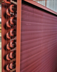 Close shot of copper plain tubes of a condenser coil coated with anti-corrosion paint. - obrazy, fototapety, plakaty