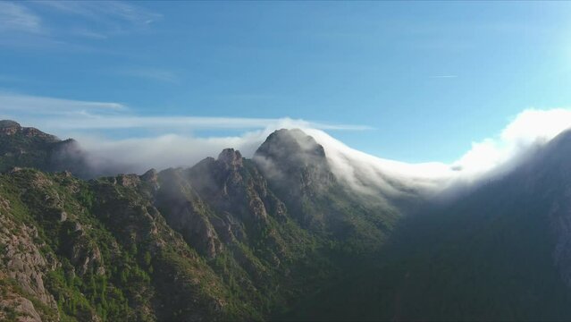 Majestic view of Sant Salvador de les Espases, cliff shrouded in fog