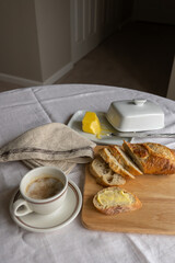 French breakfast charm: coffee with milk, sliced bread, and a butter dish. A delightful blend of morning simplicity and culinary elegance in a captivating tableau.