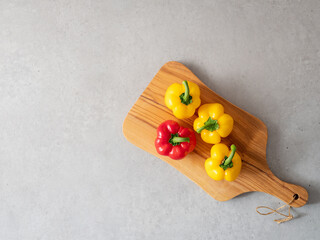 yellow and red paprika on a cutting board
