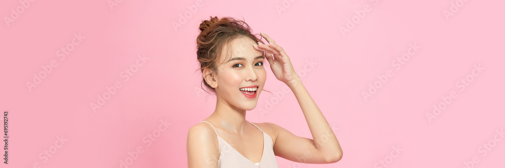 Wall mural Young woman posing alone, portrait isolated on pink studio background