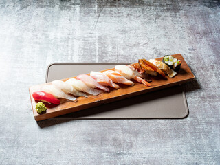 Various sushi on wooden tray