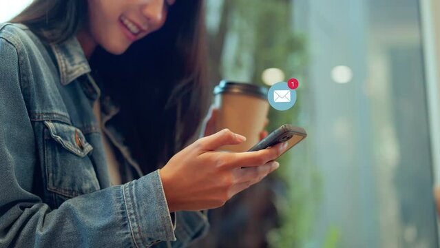 Woman hands using smartphone with 1 new email alert sign icon pop up, Female using phone for check email for work or sending text SMS short message while holding coffee cup at cafe.