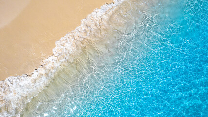 Aerial view of the beach and water on the island. During the summer the sun hits the sandy beach. Sparkling sea water. For a summer vacation idea.	
