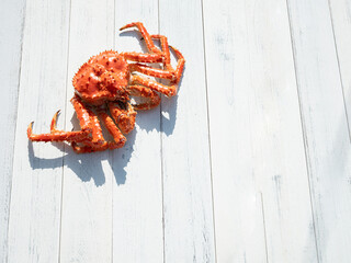 King crab on white wooden background © mnimage