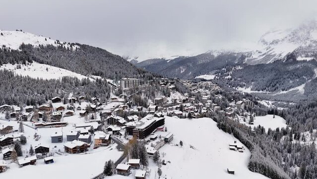 Arosa, a famous tourist spot in Switzerland. Drone flight over town and valley in winter. 